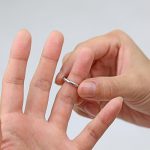 死後離婚のために結婚指輪を外す様子